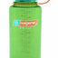 Green Nalgene water bottle with blue lid on a white background