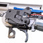 Close-up of a gun's trigger mechanism with visible wiring on a white background