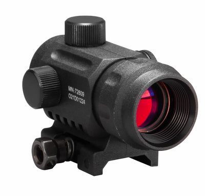 A black tactical red dot sight rifle scope with a red laser lens visible, featuring adjustment knobs and a mounting base, shown on a plain white background.
