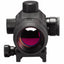 A black tactical rifle scope with a textured matte finish, featuring a prominent pink and orange iridescent lens coating, shown against a solid white background.
