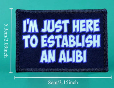 Patch with text 'I'm just here to establish an alibi' on a green background
