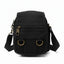 Black crossbody bag with gold accents on a white background