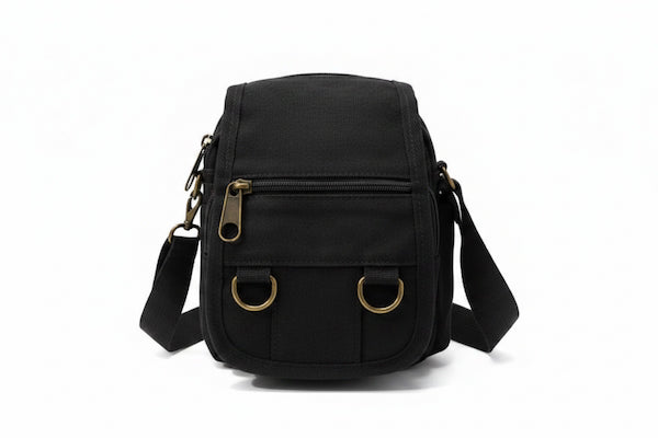 Black crossbody bag with gold accents on a white background