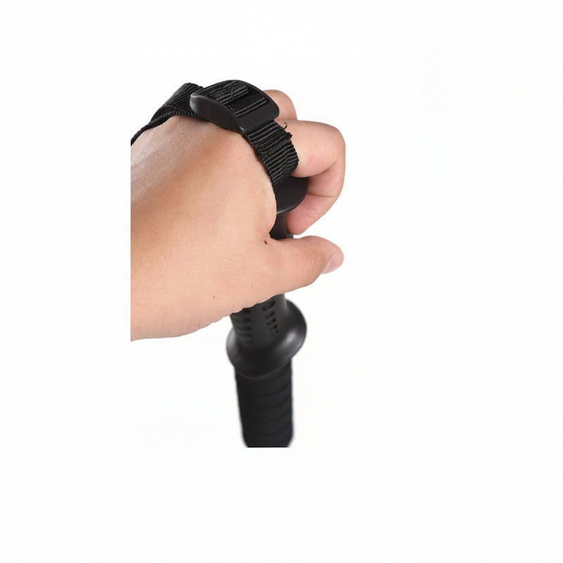 A close-up of a person's hand wearing a black wrist strap with a black handle attachment, shown against a plain white background.