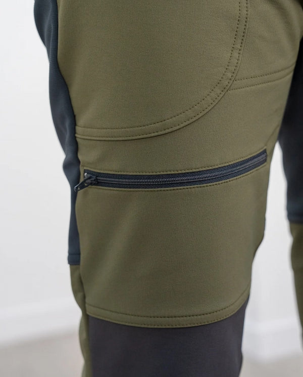 Close-up of a green and black jacket with a zipper on a white background