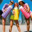 Three women holding colorful water bottles against a cityscape background