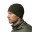 Man wearing a green beanie and jacket on a white background
