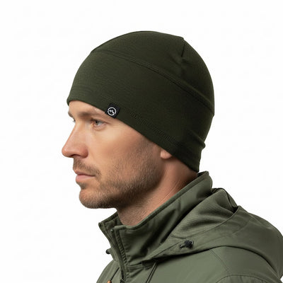 Man wearing a green beanie and jacket on a white background