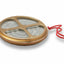 Round metal strainer with a red string on a white background