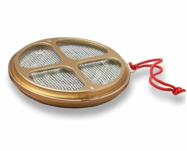 Round metal strainer with a red string on a white background