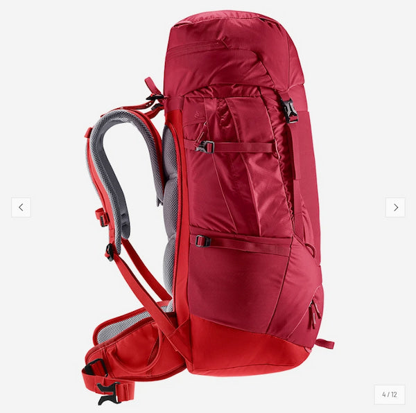A red hiking backpack shown from the back side against a light gray background, featuring gray padded shoulder straps and multiple zippered compartments.