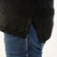 Black sweater and blue jeans on a white background