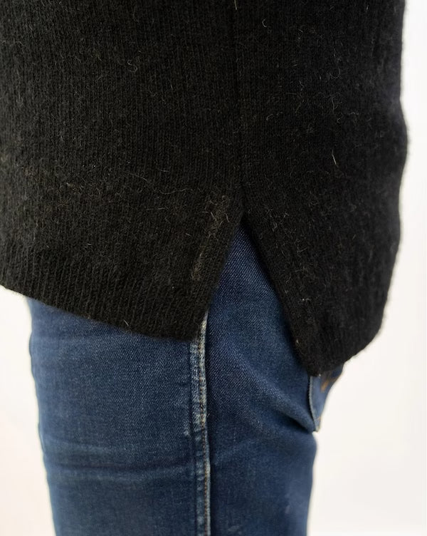 Black sweater and blue jeans on a white background