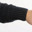 Black knit glove on a white background