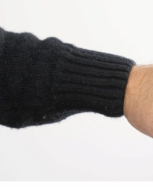 Black knit glove on a white background