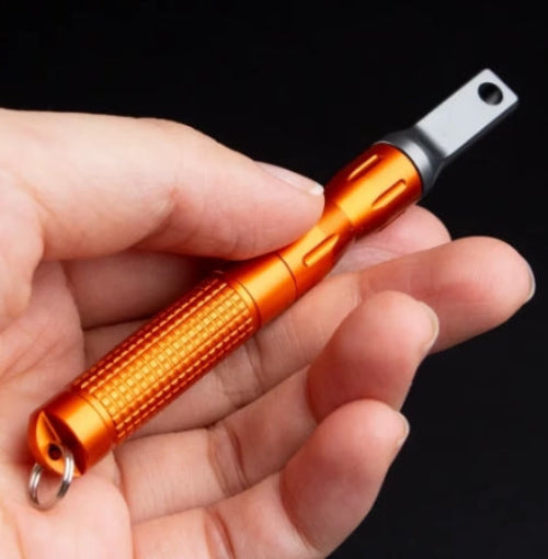 Orange pen light held in a hand against a black background