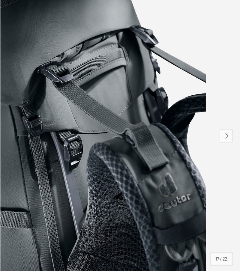 Close-up of a dark gray and black hiking backpack showing the hip belt, compression straps, and padded shoulder area with the Deuter logo.