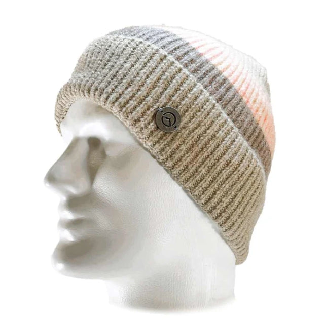 A ribbed knit beanie hat displayed on a white mannequin head. The hat features horizontal stripes in beige, gray, and a soft peach-pink, with a small round dark button on the side.