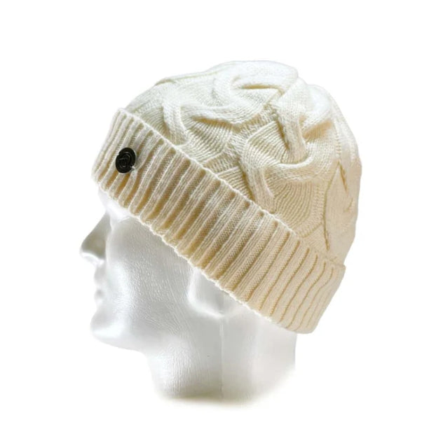 An off-white cable-knit beanie hat with a ribbed cuff and a small black button, displayed on a white mannequin head against a white background.