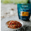 Spaghetti dish on a plate with a Back Country brand package in the background