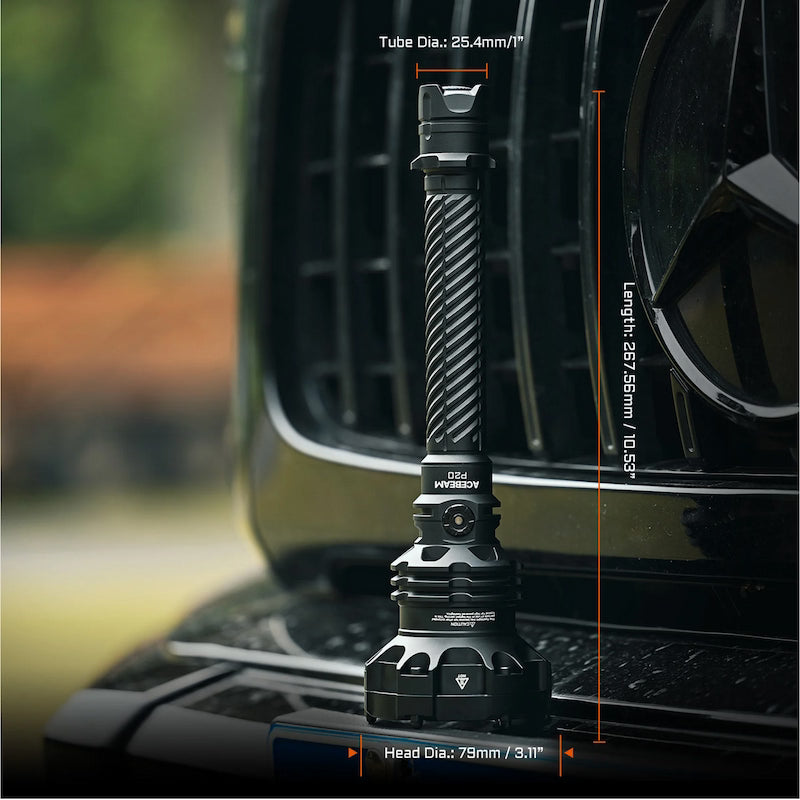 Black flashlight on a car grill with measurements displayed