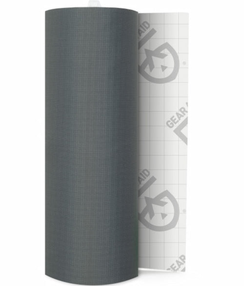 A roll of dark gray textured material, partially unrolled to reveal a white backing with a grid pattern and a repeating Gear Aid logo.