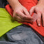 Person applying a patch to a piece of fabric with another patch already attached.