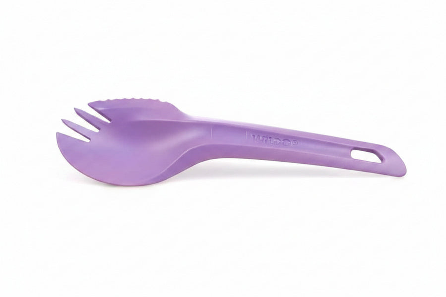 A purple plastic spork with a handle, photographed on a clean white background.