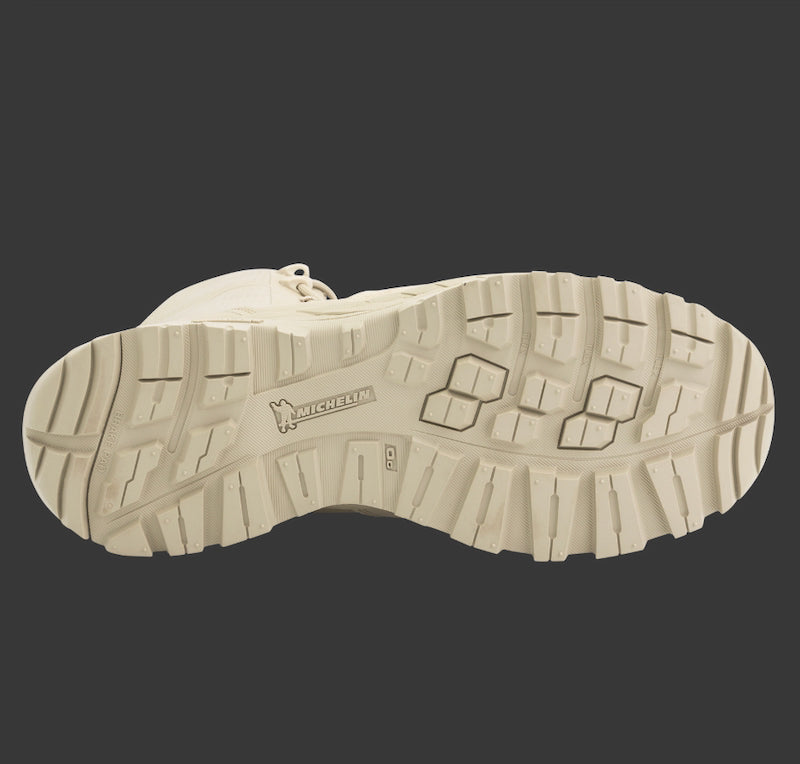 Close-up of a beige boot sole with Michelin logo on a black background