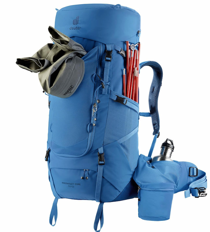 Blue hiking backpack with accessories on a white background