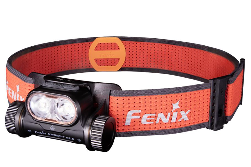 Fenix headlamp with orange strap on a white background