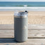 Gray insulated tumbler on a wooden deck with ocean view
