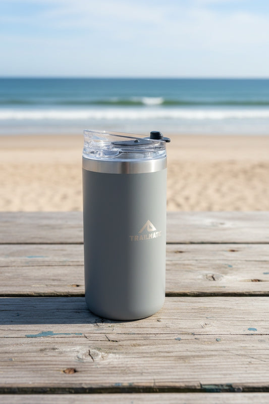 Gray insulated tumbler on a wooden deck with ocean view