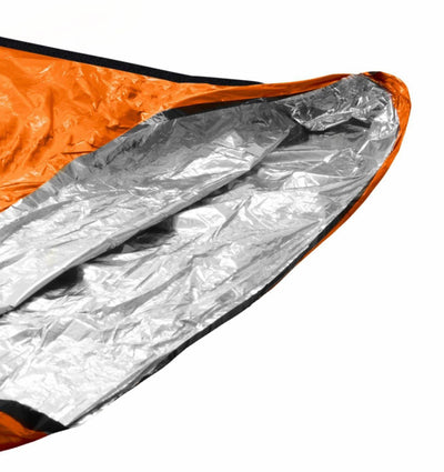 Close-up of a reflective silver mylar blanket with orange border on a white background