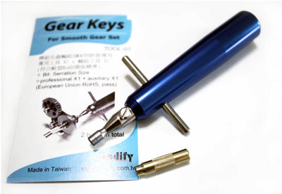 Blue tool with gold bit on a white background with a blue and white manual.