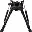 Black carbon fiber tripod with a quick-release head and leg springs, shown against a solid white background.