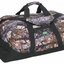 A camouflage duffle bag with a woodland tree-bark and leaf pattern, featuring black handles, a black base, and a front zippered pocket with a green logo patch.