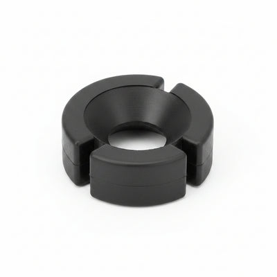 A black circular plastic ring with a central hole and three outer flanges, photographed on a clean white background.