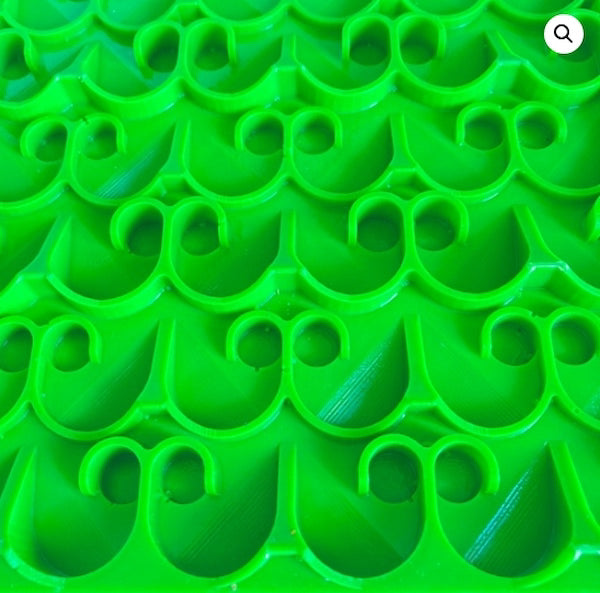 Close-up of green plastic clips with a pattern