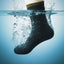 A black sock floating underwater with water splashing around it and a blue gradient background.