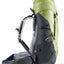 A hiking backpack shown from the side against a plain white background. The backpack features a light olive green top section and a dark gray lower section, with gray mesh padding on the shoulder straps.