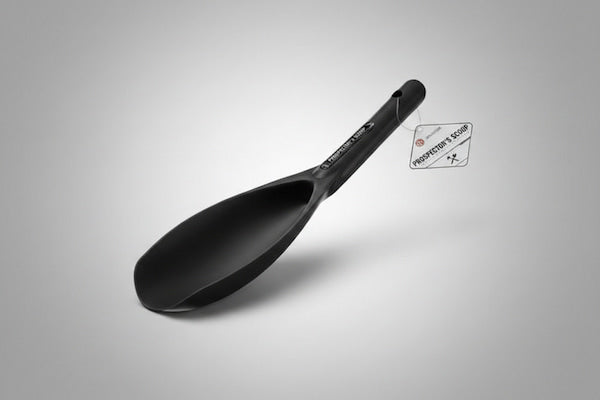 Black ladle with a label on a gray background