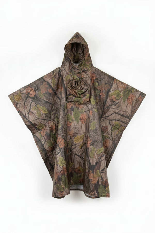 A hooded rain poncho with a woodland camouflage pattern featuring brown branches, green leaves, and beige/tan foliage, displayed against a plain white background.