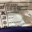 Close-up of a garment care label showing washing instructions, including 'Wash as Cotton', 'Use synthetic detergent only', 'DO NOT USE SOAP', 'DO NOT BLEACH', and 'Hot Iron'.