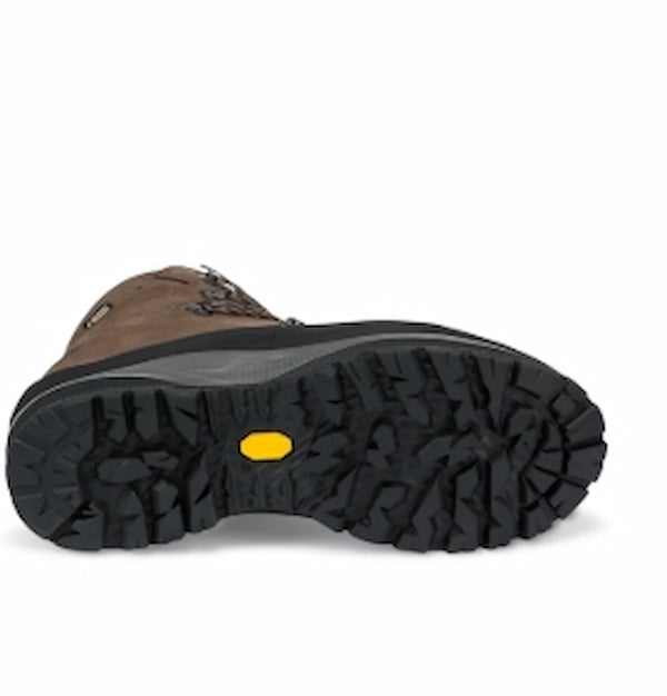 Close-up of a brown boot sole with a yellow label on a white background