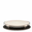 Round ceramic plate with a black base on a white background