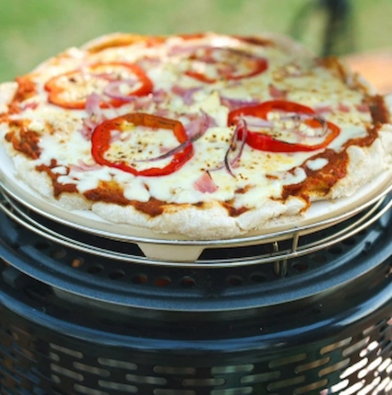 Pizza with tomato slices on a grill