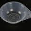 Clear plastic measuring cup with brand logo on a black background