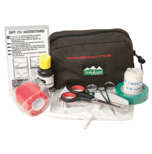 A Pro Dog Emergency Stitching kit displayed on a white background, containing a black zippered pouch with red and green branding, scissors, a small bottle with a yellow cap, a roll of red tape, a roll of white tape, and an instruction sheet.