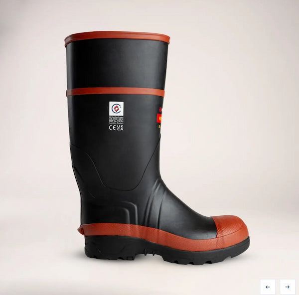 Black rubber boot with red trim on a light beige background